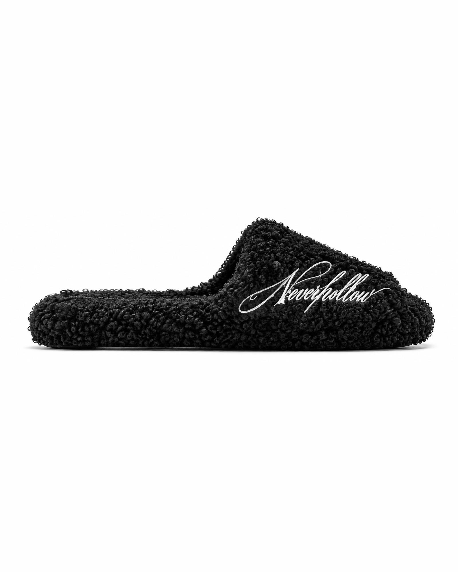 A Haven Slide in obsidian from the side, showing the textured pile and the script on the strap