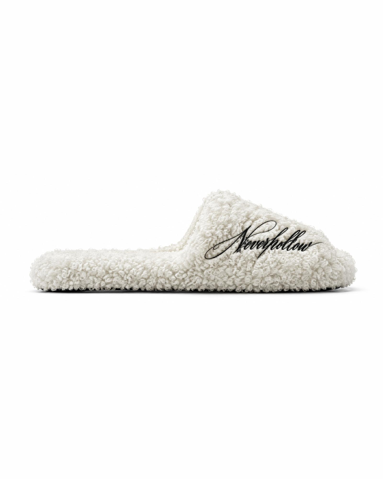 A Haven Slide in bone from the side, showing the textured pile and the script on the strap